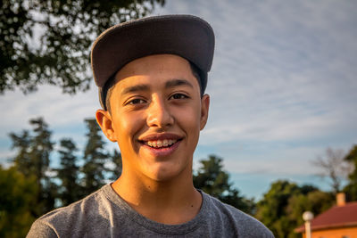 Portrait of smiling teenage boy wearing cap