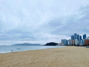 Scenic view of beach against sky in city