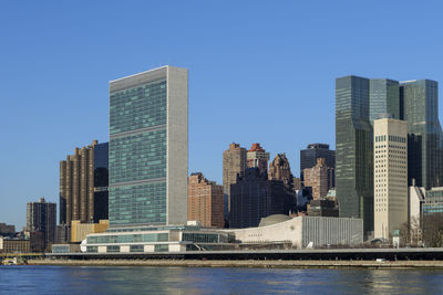 United nations building view on a clear blue day, midtown manhattan skyline, new york city