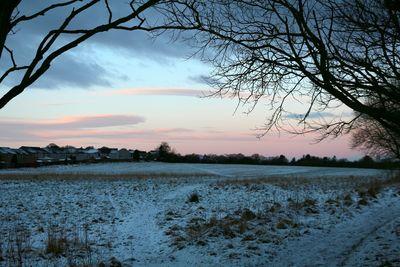 Scenic view of landscape against sky during winter