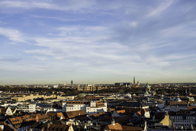 Aerial view of cityscape against blue sky