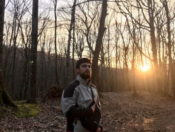 Full length of young man standing in forest