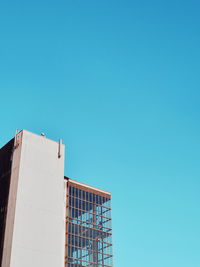 Low angle view of building against clear blue sky