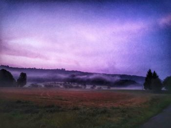 Scenic view of field against sky during sunset