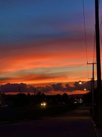 Silhouette city against sky during sunset