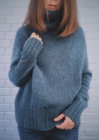 Midsection of woman standing against wall in winter