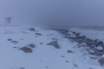 Scenic view of sea against sky during winter