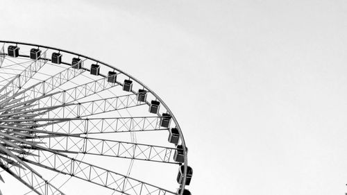 Low angle view of ferris wheel against sky