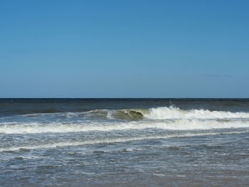 Scenic view of sea against clear blue sky