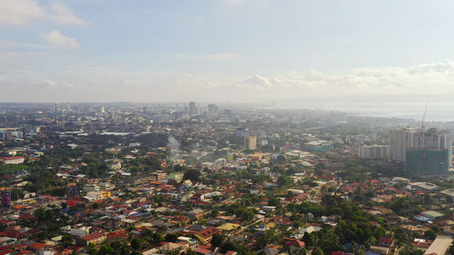 High angle view of city buildings against sky