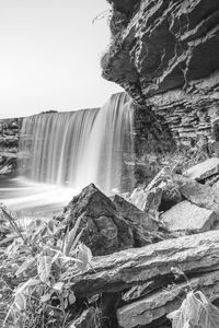 Scenic view of waterfall against rocks