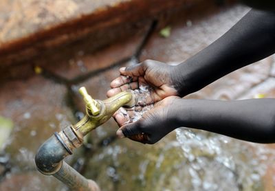 Close-up of hand holding stick water