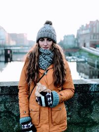 Portrait of woman standing in city during winter