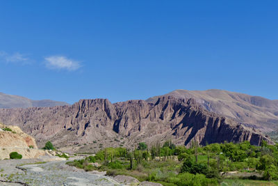 Scenic view of mountains against clear blue sky