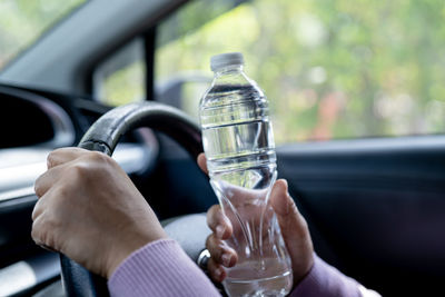 Cropped image of man holding drink