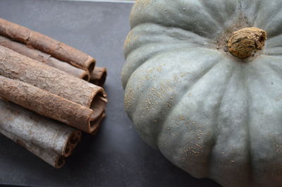 High angle view of white pumpkin and cinnamon on table