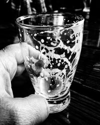 Close-up of cropped hand holding glass