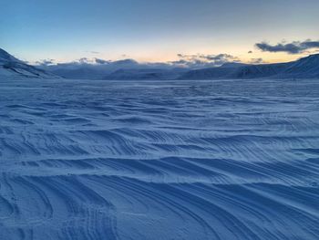 Scenic view of snowcapped mountains against sky during winter