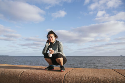 Girl squatting thinking after exercise