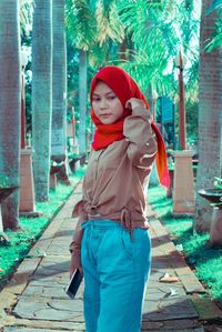 Portrait of young woman standing outdoors