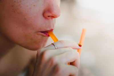 Close-up of woman holding cigarette