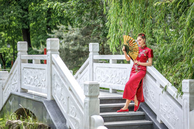 Low angle view of woman standing on staircase