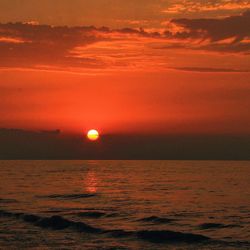 Scenic view of sea against romantic sky at sunset