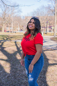 Portrait of smiling young woman standing outdoors