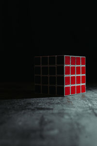 Close-up of stack on table against black background