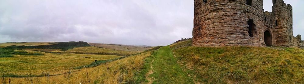 Panoramic view of castle on field against sky