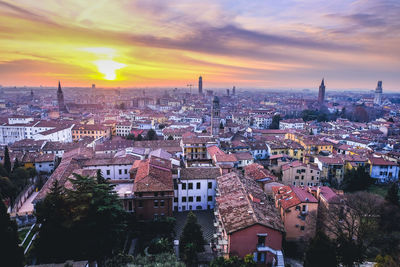 High angle view of buildings in city against sky during sunset