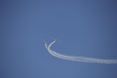 Low angle view of airplane flying in sky