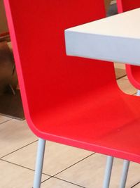 High angle view of red chair against wall