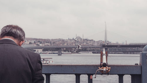 Rear view of man looking at cityscape