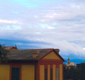 Low angle view of building against cloudy sky