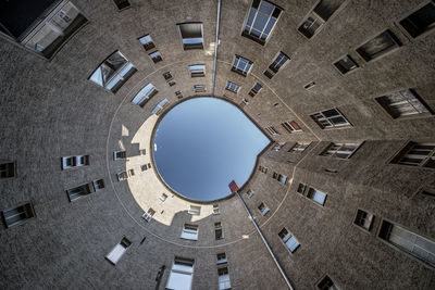 Directly below shot of buildings against clear sky