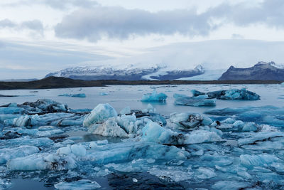 Scenic view of frozen lake against sky