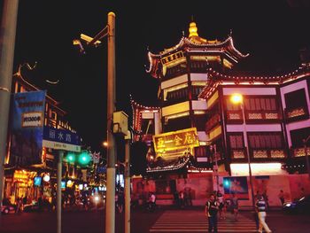 Illuminated city street at night