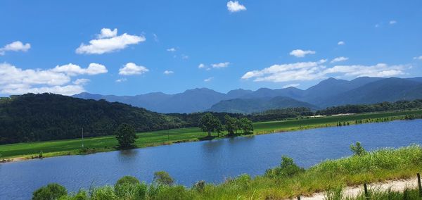 Scenic view of lake and mountains against sky