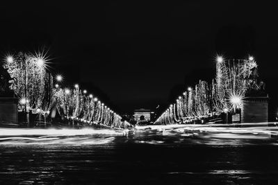 Firework display over illuminated city at night
