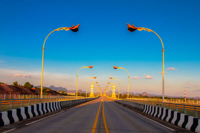 Road against blue sky during sunset