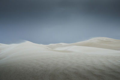 Scenic view of arid landscape against sky