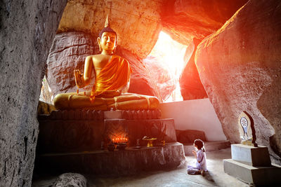 Girl playing at buddha temple