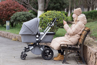 Rear view of man using mobile phone