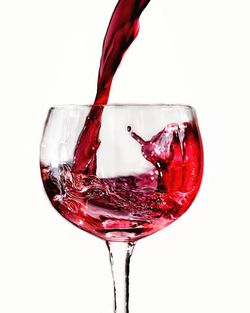 Close-up of red wine against white background