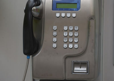 Close-up of telephone booth on wall