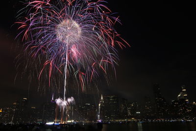 Low angle view of firework display at night