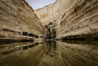 Group of people walking by mountain