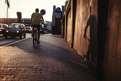 Man on bicycle in the city at sunset