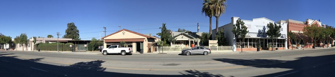 Cars on road against clear blue sky